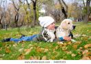 boy-playing-in-autumn-park-with-a-golden-retriever-64605331-thumbnail