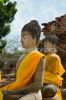 3683257-two-buddha-statues-wrapped-in-an-orange-scarf-thumbnail