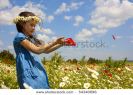 sweet-little-girl-on-the-beauty-field-with-wild-flowers-54340696-thumbnail