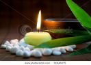 white-zen-stones-burning-candle-bamboo-leaves-and-clay-bowl-thumbnail