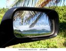 view-of-sea-and-mountains-in-rear-view-mirror-of-car-thumbnail