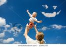 father-throw-his-daughter-over-blue-sky-and-clouds-smile-thumbnail