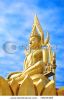 gold-buddha-statue-is-on-the-sky-background-72933469-thumbnail