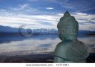 back-view-of-buddha-statue-overlooking-a-peaceful-mountain-lake-13773391-thumbnail