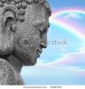 face-of-a-buddha-with-eyes-closed-in-prayer-with-a-blue-sky-and-double-rainbow-in-reflection-in-thumbnail